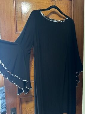 Dress black dress long sleeve flare at wrist and scoop neck and animal print.
